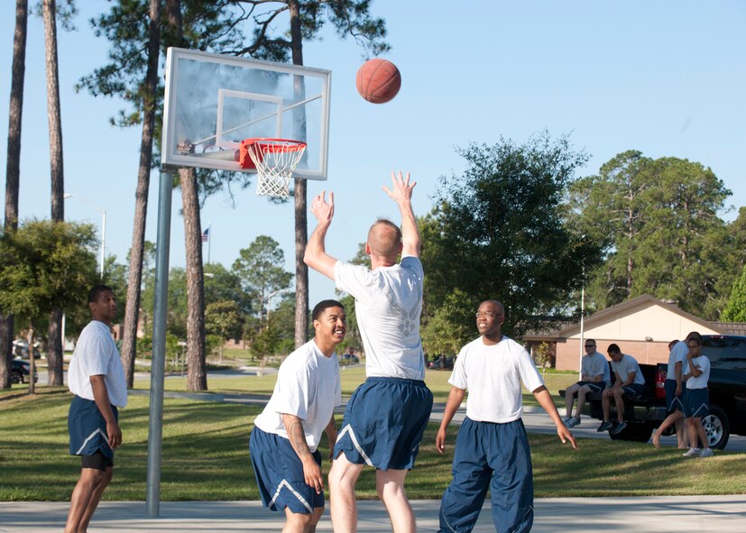 Members of the 23d Maintenance Group play basketball during the MXG Sports Day , at Moody Air Force base, Ga., April 27, 2012. Different MXG squadrons competed against each other to gain the most points and win a trophy at the end of the event.  (U.S. Air Force photo by Senior Airman Eileen Meier/Released)