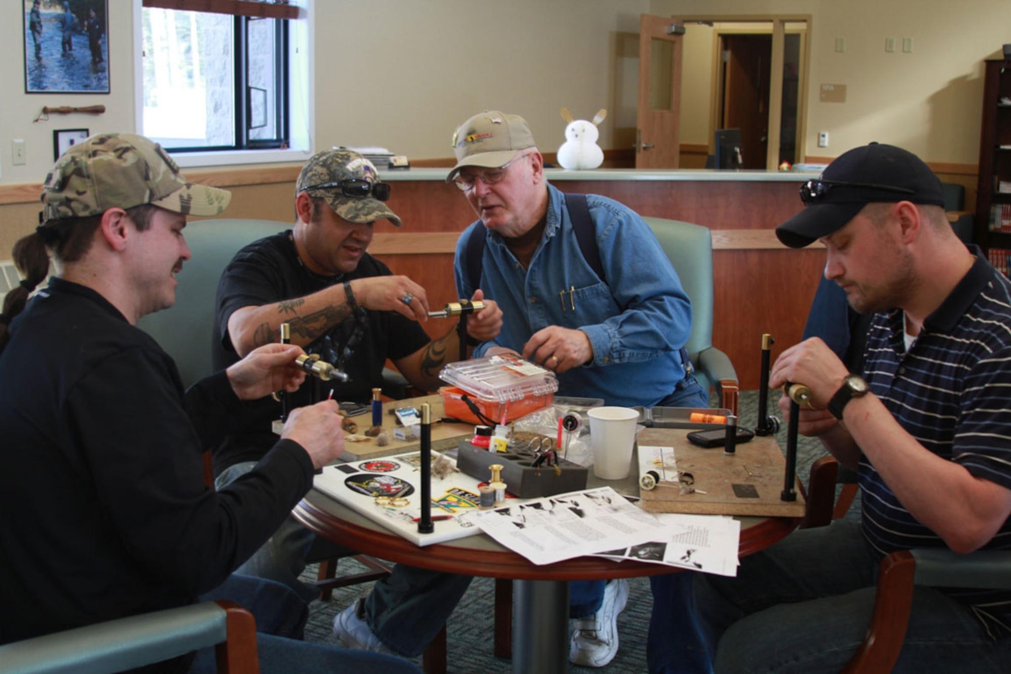 Veterans and volunteers work together during the Healing Waters fly tying class April 12 at JBER. (U.S. Army photo/Spc. Juana Nesbitt)