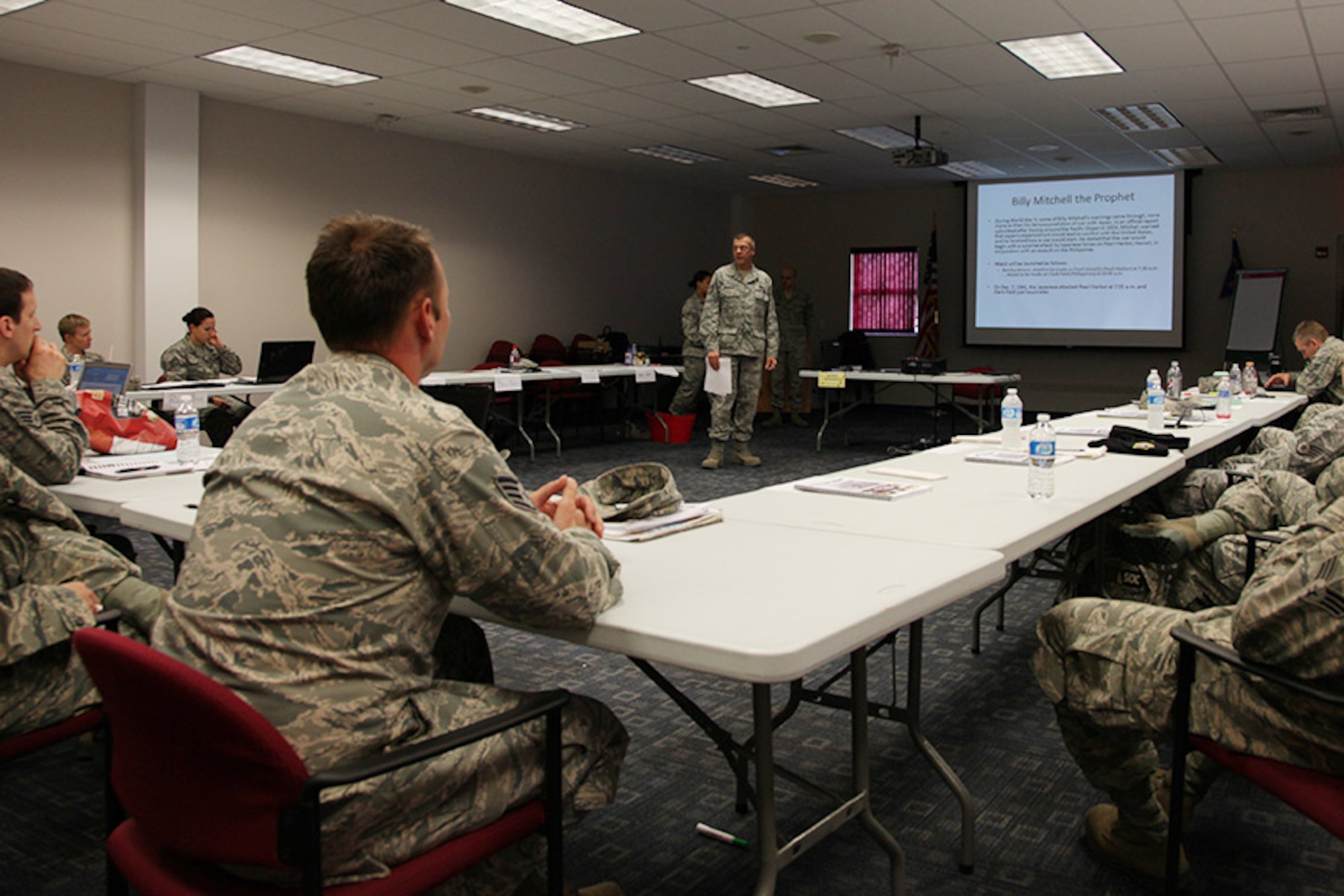 Military members from the 911th Airlift Wing partake in a team project in which they brief fellow Airmen about the history of the Air Force’s key leaders during a 10 day first-line supervisor's course held at the 32nd Aerial Port Squadron briefing room on May 2, 2012. The Air Force Reserve Command's first-line supervisor's course provides  leadership and management training for mid-level noncommissioned officers and addresses the unique challenges faced by citizen Airmen who have to balance priorities between military and civilian careers. (U.S. Air Force photo by Tech. Sgt. Ralph Van Houtem/ Released)