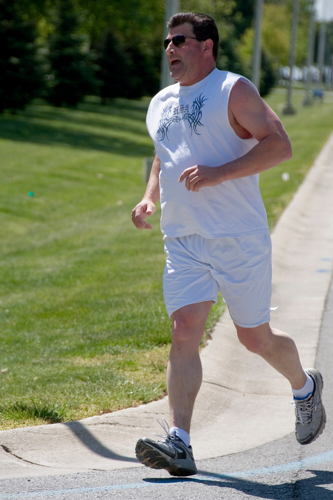 GRISSOM AIR RESERVE BASE, Ind. -- Aaron Wilson, a structural repair technician with the 434th Maintenance Squadron, rounds the corner heading into the final stretch of a base 5k run.  Wilson finished second in the event, which called for members to predict their times. He was 39 seconds off his predicted time. (U.S. Air Force photo/Tech. Sgt. Douglas Hays)