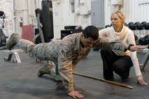 MINOT AIR FORCE BASE, N.D. -- Ty Colvin, Certified Strength and Conditioning Specialist and Licensed Athletic Trainer, works with Senior Airman Luis Velasquez, 91st Security Forces Group Tactical Response Force member, in a doctoral physical assessment at Minot Air Force Base. TRF members are currently participating in a doctoral study which assesses any physical weaknesses or injuries they may have and works to correct those impediments. (U.S. Air Force photo/Airman 1st Class Andrew Crawford)