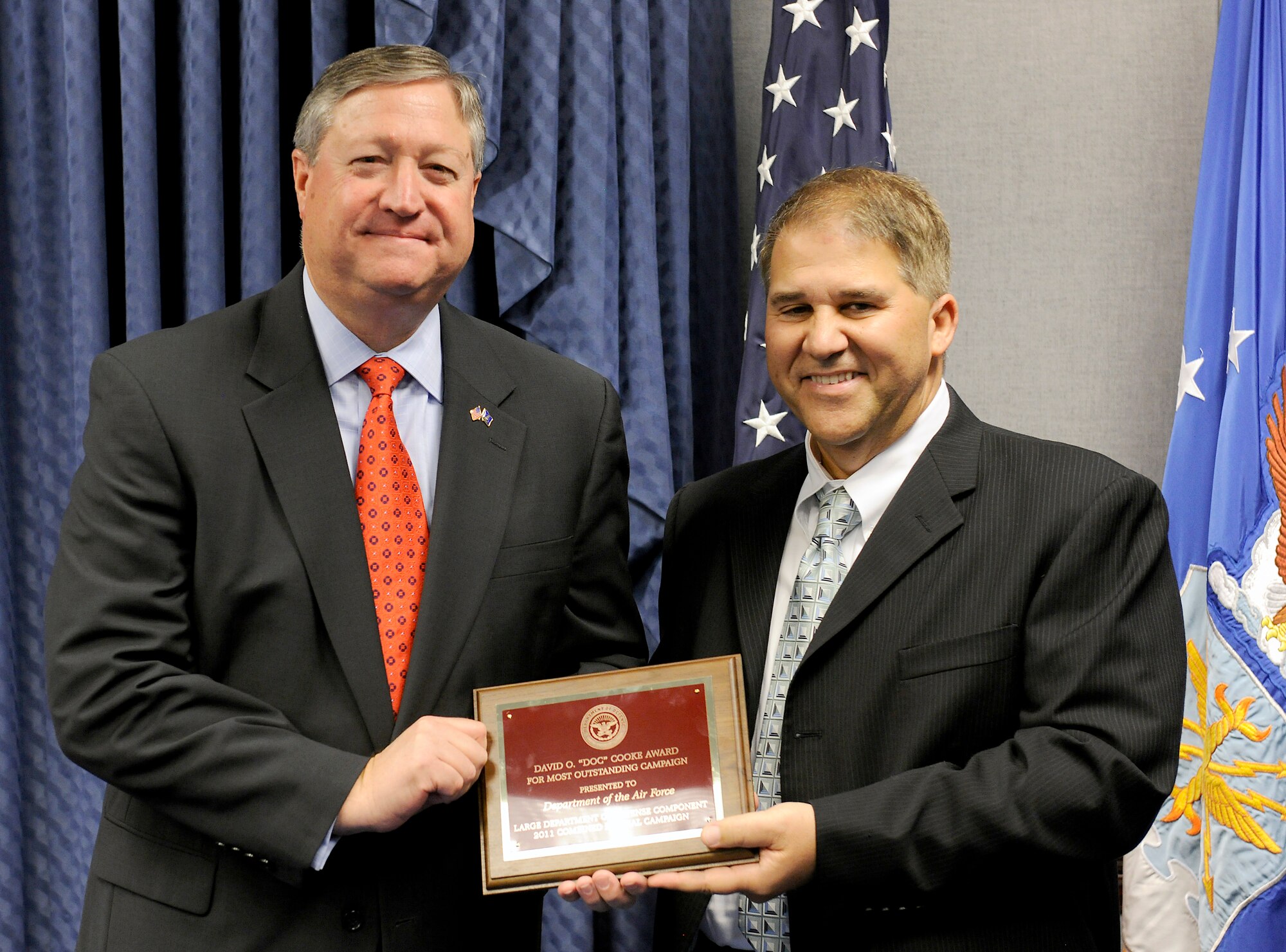 Secretary of the Air Force Michael Donley accepts the Combined Federal Campaign DOD Outstanding Large Campaign from Louis Torchia on May 2, 2012, during a Pentagon ceremony. Torchia is the director of the DOD Voluntary Campaign Management Office. (U.S. Air Force photo/Scott M. Ash)