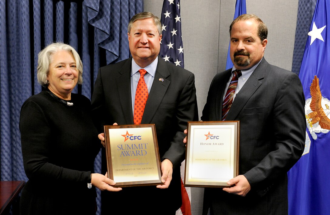 Secretary of the Air Force Michael Donley and Timothy Beyland accept the Combined Federal Campaign Summit and Honor awards from Renée S. Acosta May 2, 2012, during a Pentagon ceremony. Beyland is an the administrative assistant to the secretary of the Air Force, and Acosta is the president of the Global Reach Foundation. (U.S. Air Force photo/Scott M. Ash)