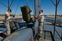 BARKSDALE AIR FORCE BASE, La. - Staff Sgt. Brad Davis and Tech. Sgt. Kevin Rowe, 96th Aircraft Maintenance Unit crew chiefs, lower a new drag chute into the tail of a B-52H Stratofortress at Barksdale Air Force Base, La., April 18, 2012. The drag chute is a parachute that is deployed after landing to help the B-52H slow down. (U.S. Air Force photo/Senior Airman Marleah Miller) 