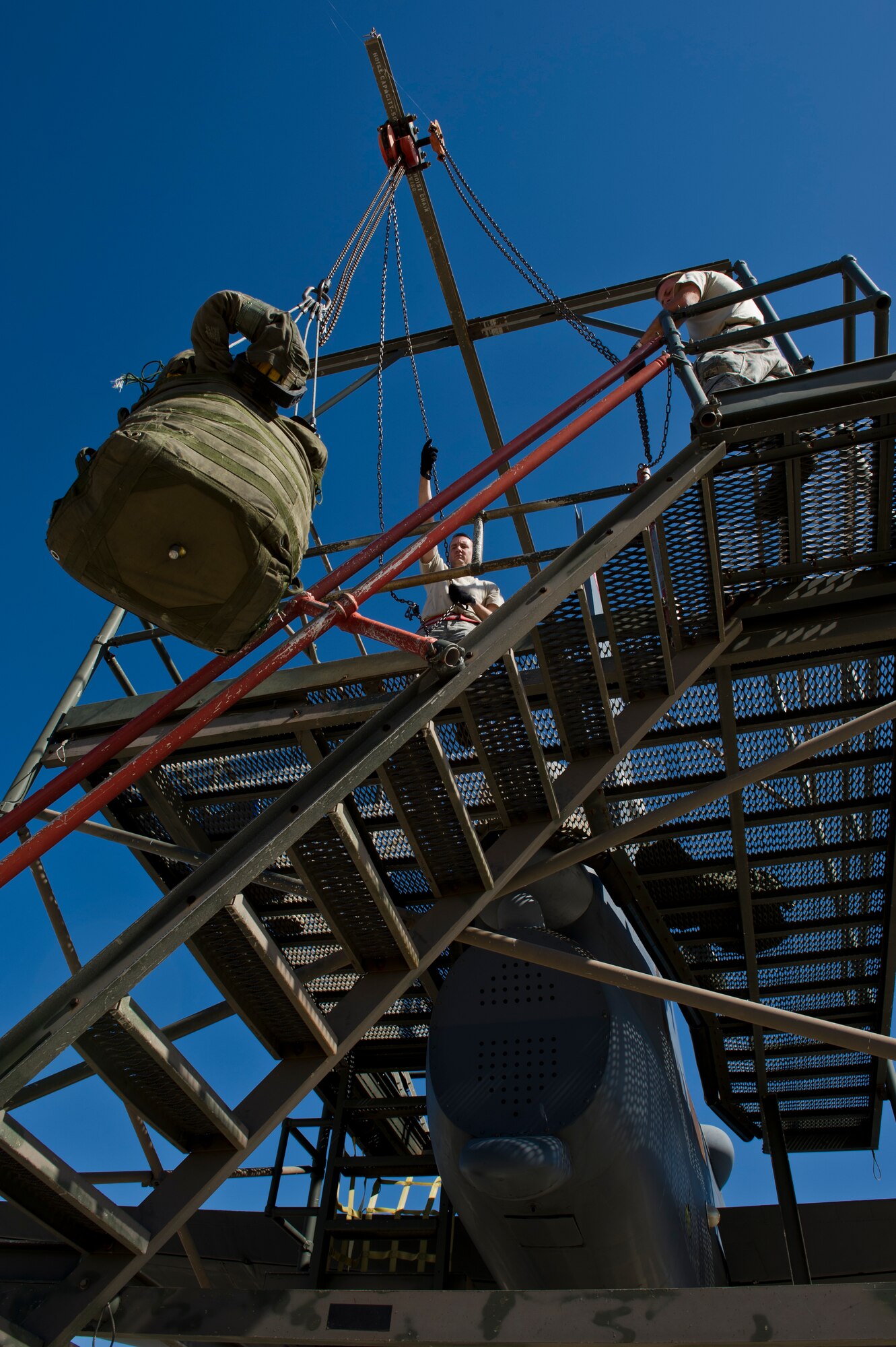 BARKSDALE AIR FORCE BASE, La. - Staff Sgt. Brad Davis and Tech. Sgt. Kevin Rowe, 96th Aircraft Maintenance Unit crew chiefs, lift a new drag chute to be placed in the tail of a B-52H Stratofortress at Barksdale Air Force Base, La., April 18. The drag chute is a parachute that is deployed after landing to help the B-52H slow down. (U.S. Air Force photo/Senior Airman Marleah Miller) 
