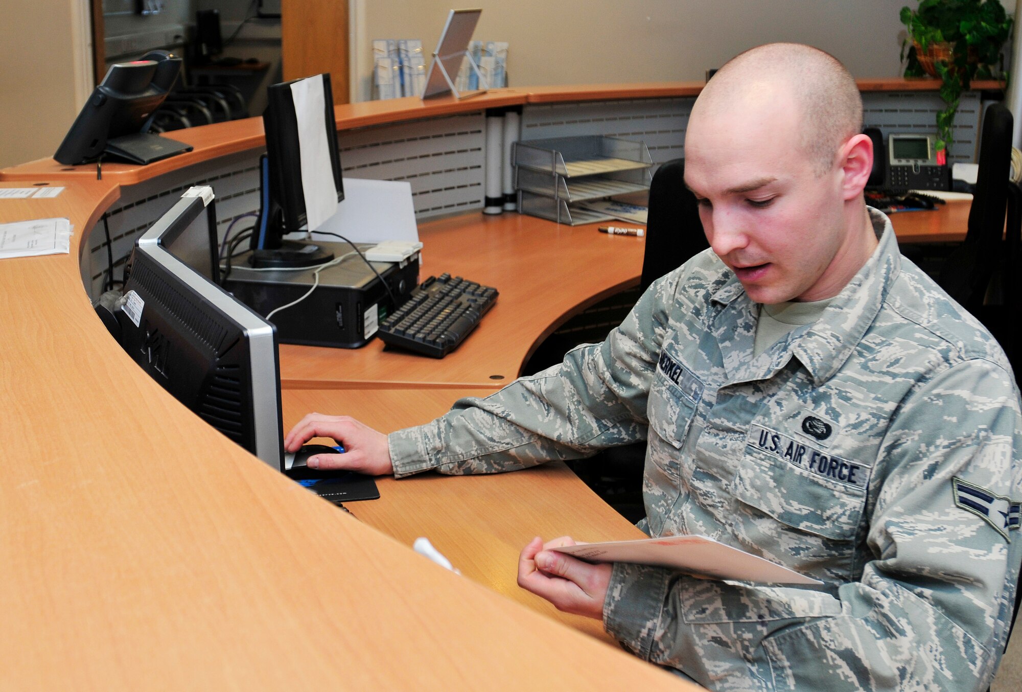 ROYAL AIR FORCE LAKENHEATH, England - Airman 1st Class William Merkel, 48th Force Support Squadron customer support journeyman, looks over a document at the 48th FSS military personnel flight May 3, 2012. Merkel was nominated for a Liberty Spotlight because he displays the core value of "Service Before Self." (U.S. Air Force photo by Senior Airman Tiffany M. Deuel)