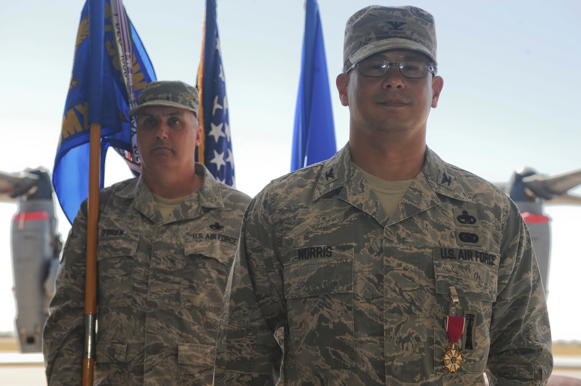 U.S. Air Force Col. Wesley Norris stands in front of Chief Master Sgt. Daniel O’Brien before the traditional passing of the guidon at the 27th Special Operations Maintenance Group change of command ceremony at Cannon Air Force Base, N.M., May, 1, 2012. The change of command is a military tradition which dates back to the 18th century. (U.S. Air Force photo by Airman 1st Class Eboni Reece)