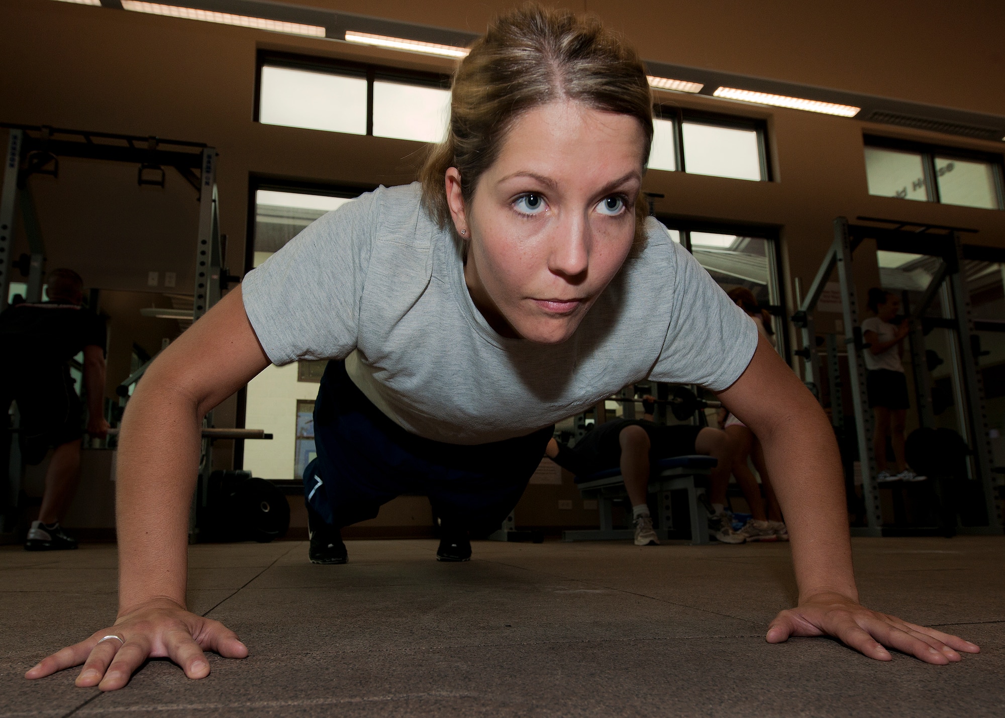 Senior Airman Karla Burns, of the 96th Air Base Wing staff, uses the proper form while practicing her push-ups during her morning workout routine May 3 at Eglin Air Force Base, Fla.  Burns struggled to complete the required amount of push-ups during her recent physical training tests.  With the help of the fitness center staff, she began a workout plan that allowed her to excel and pass her test.  (U.S. Air Force photo/Samuel King Jr.)