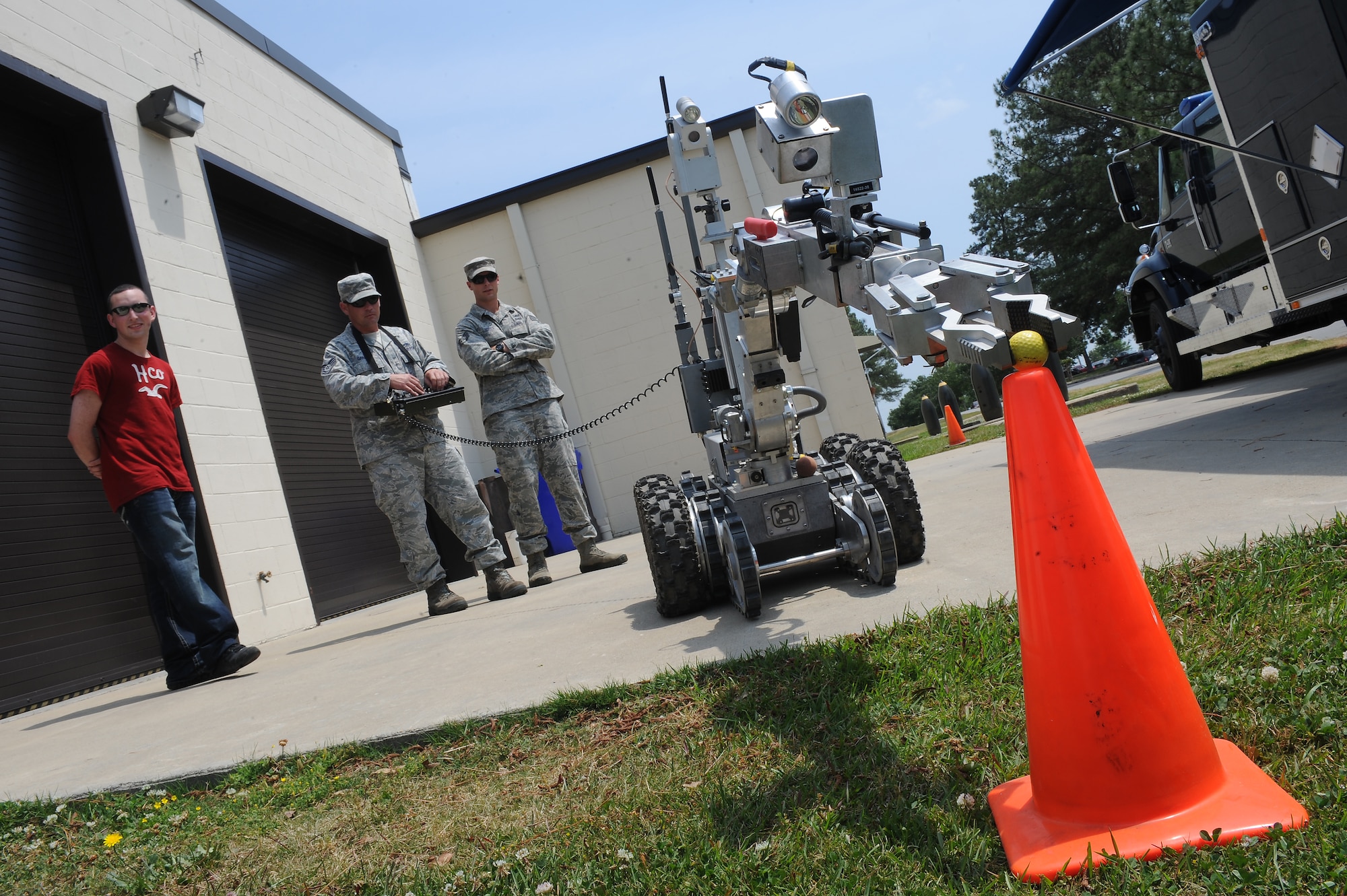 U.S. Air Force Tech. Sgt. Jeff Garren (center) demonstrates the functions of the F6-A explosive ordnance disposal robot to Airman 1st Class Maurice Aldrich (left) and Staff Sgt. Adam Usher during an EOD open house on Seymour Johnson Air Force Base, N.C., May 1, 2012. The F6-A has multiple uses to include scouting, explosives diffusion and transporting hazardous material. Garren, 372nd Training Squadron mission ready airmen instructor, hails from Greenville, S.C. Alrich, 4th Component Maintenance Squadron avionics apprentice, is from Erie, Pa. Usher, 4th Civil Engineer Squadron EOD journeyman, is a native of Langhorne, Pa. (U.S. Air Force photo/Airman 1st Class John Nieves Camacho/Released)