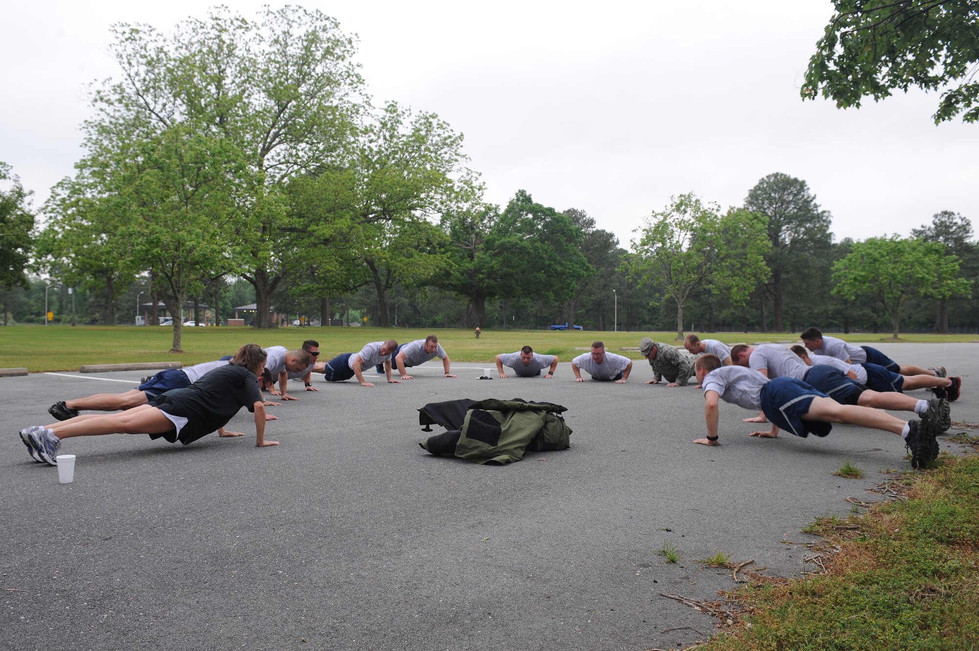 Explosive ordnance disposal Airmen perform push-ups around an EOD 9-bomb disposal suit after completing a six-mile run on Seymour Johnson Air Force Base, N.C., May 1, 2012. The Airmen performed 20 push-ups to honor the 20 Air Force EOD technicians killed in action since March 29, 2006. (U.S. Air Force photo/Airman 1st Class John Nieves Camacho/Released)