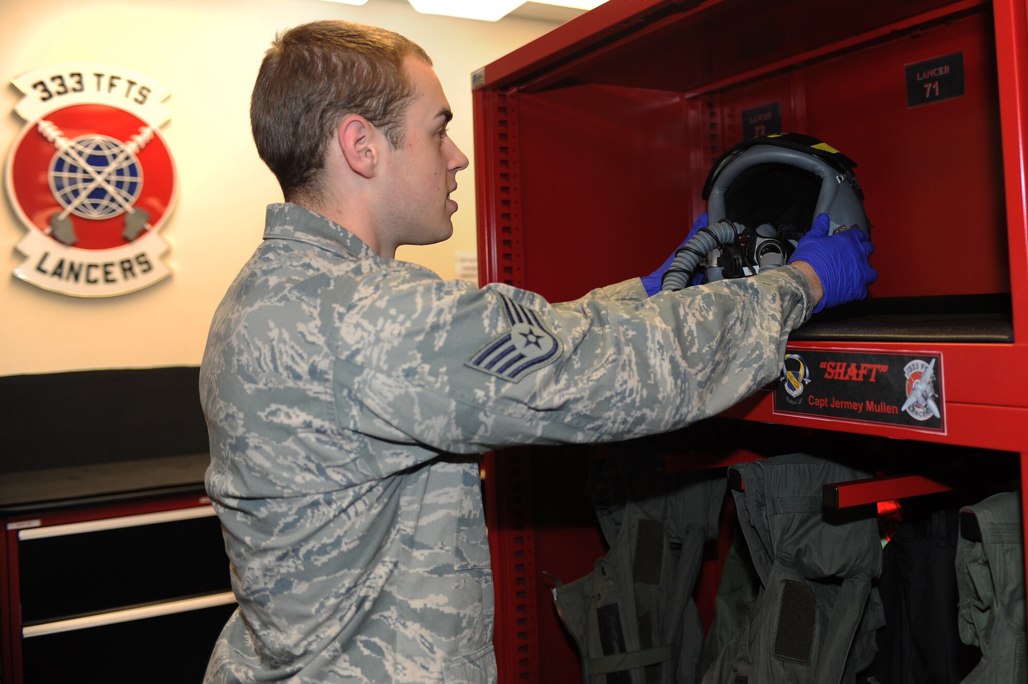 U.S. Air Force Staff Sgt. Dain Boelter places a HGU-55P flyers helmet on a shelf in the 333rd Fighter Squadron’s aircrew flight equipment shop on Seymour Johnson Air Force Base, N.C., May 1, 2012. After each flight the helmets are inspected, cleaned, reconstructed and returned to the aircrew member’s locker. Boelter, 4th Operations Support Squadron AFE journeyman, is a native of Mendota Heights, Minn. (U.S. Air Force photo/Airman 1st Class John Nieves Camacho/Released)