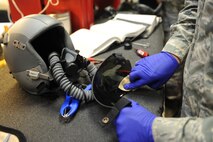 U.S. Air Force Staff Sgt. Dain Boelter cleans the visor on a HGU-55P flyers helmet in the 333rd Fighter Squadron’s aircrew flight equipment shop on Seymour Johnson Air Force Base, N.C., May 1, 2012. The visor is cleaned after every flight as part of post-flight procedures to prevent obstructed vision while flying. Boelter, 4th Operations Support Squadron AFE journeyman, hails from Mendota Heights, Minn. (U.S. Air Force photo/Airman 1st Class John Nieves Camacho/Released)
