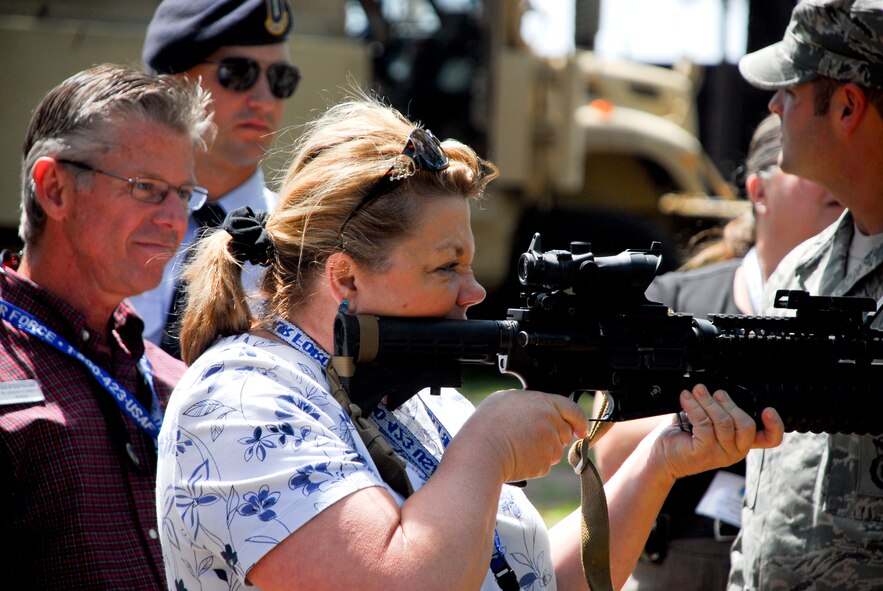 Dawn Burgstiner, Healthcare Science Technology instructor at South Effingham High School, Guyton, Ga., peers through the scope of an M4 carbine during an orientation at the 93d Air Ground Operations Wing's Military Operations in Urban Terrain Village, April 23, 2012. Burgstiner and a group of influencers from the 336th Recruiting Squadron's zone toured Moody Air Force Base, Ga.,  April 23 to 24 to learn more about Special Operations, and Science, Technology, Engineering and Math opportunities in the Air Force.(U.S. Air Force photo by Tech. Sgt. Brad Barth/Released)