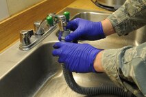U.S. Air Force Staff Sgt. Dain Boelter rinses off an HGU-55P flyers helmet oxygen hose in the 333rd Fighter Squadron’s aircrew flight equipment shop on Seymour Johnson Air Force Base, N.C., May 1, 2012. The oxygen hose plugs into an aircraft oxygen system channeling air from the jet to aircrew members. Boelter, 4th Operations Support Squadron AFE journeyman, is from Mendota Heights, Minn. (U.S. Air Force photo/Airman 1st Class John Nieves Camacho/Released)