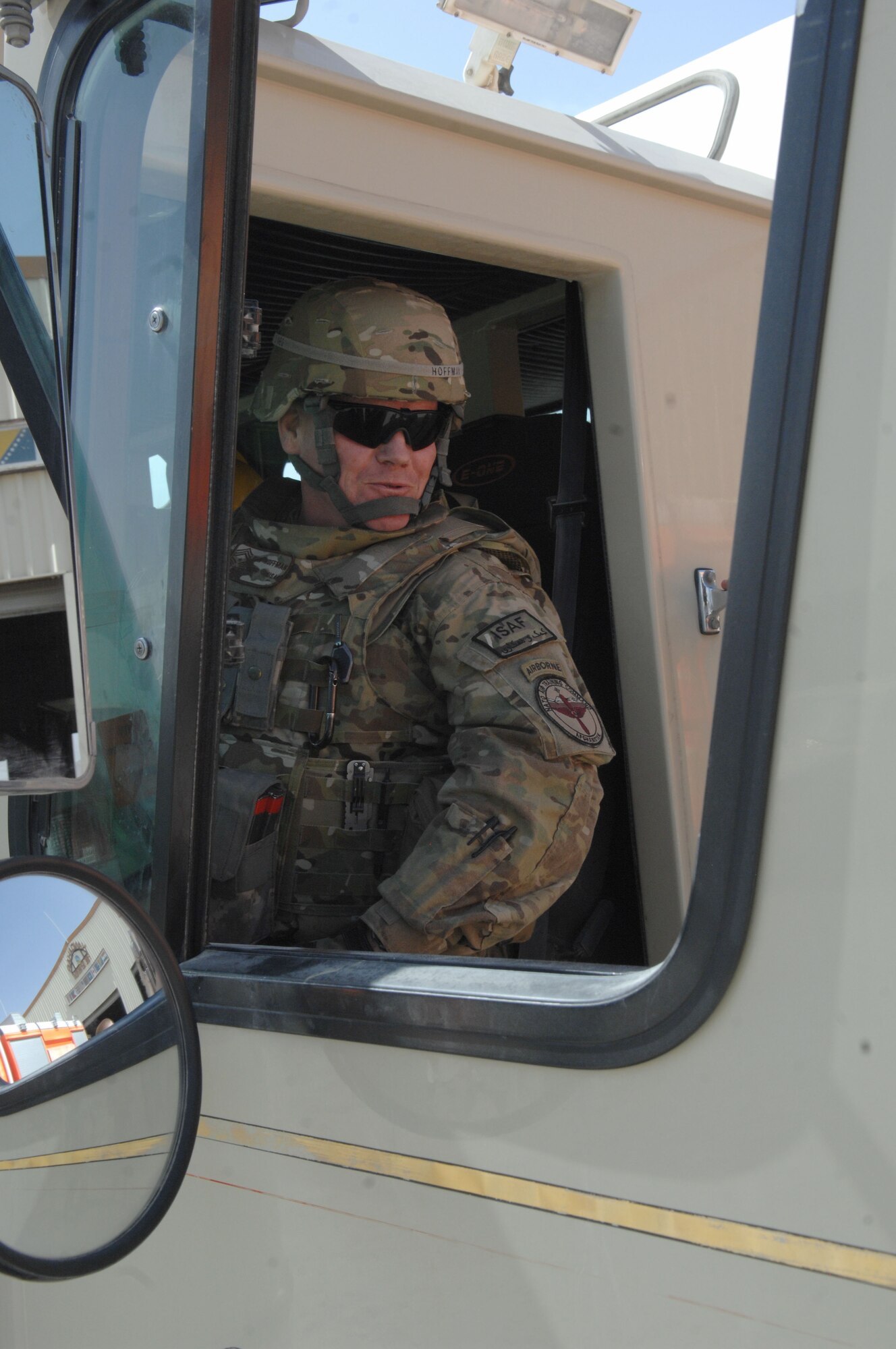 Chief Master Sgt. John Hoffman, 438th Air Expeditionary Wing command chief, takes a seat in a fire truck April 5, at Kandahar Air Base, Afghanistan. The truck and the chief both shared a past history of service for the Elkins Park, Pa., Volunteer Fire Department. (U.S. Air Force photo by Tech. Sgt. Jeremy Larlee)