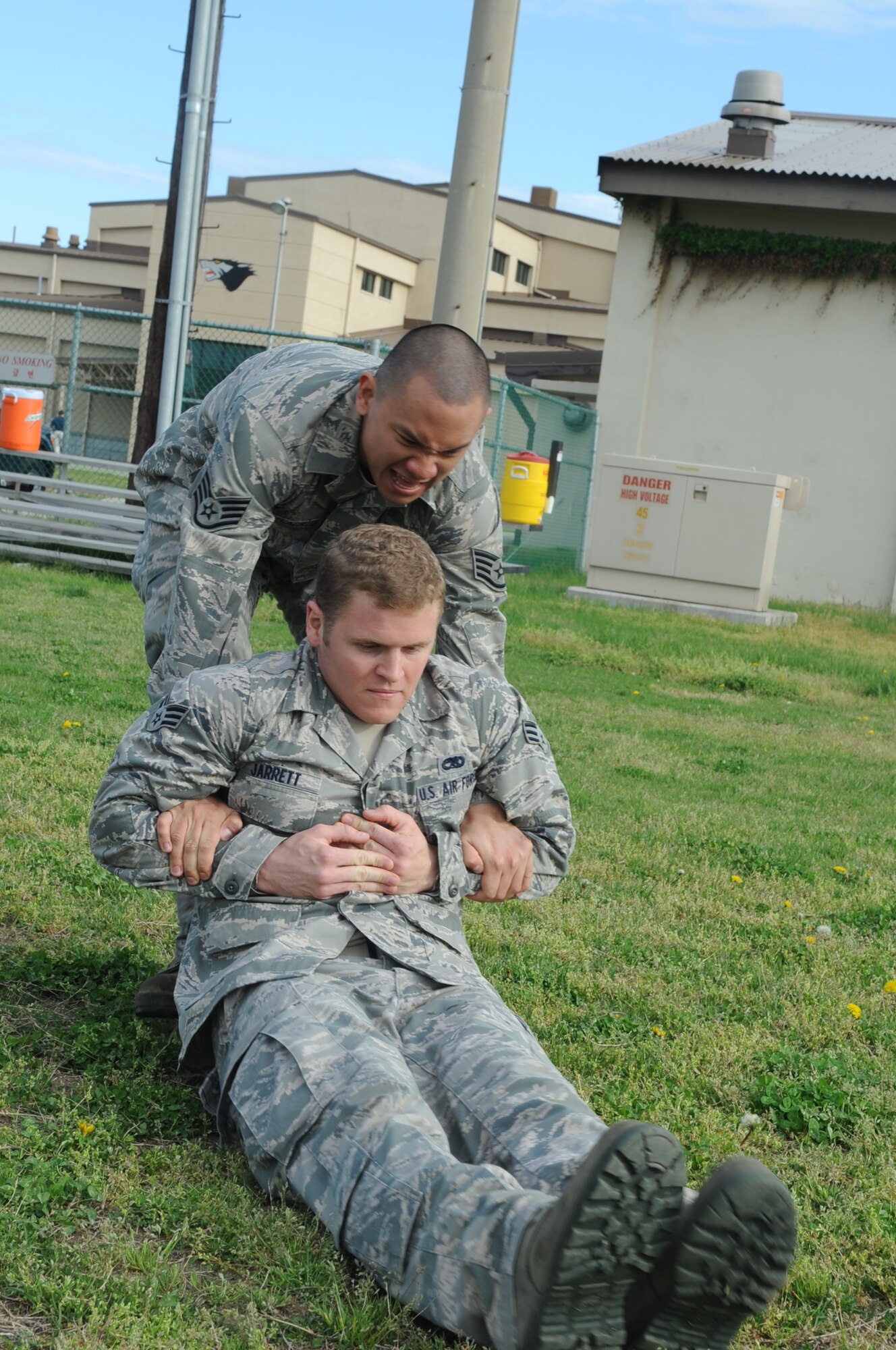 Staff Sgt. Frederick Delacruz, right, 8th Maintenance Group, drags Senior Airman Joshua Jarrett, 8th Maintenance Squadron, during a combat fitness test May 2, 2012, at Kunsan Air Base, Republic of Korea. Delazcruz than completed a fireman’s carry the rest of distance before lugging two 30-pound ammo cans 150 yards and throwing a simulated grenade. (U.S. Air Force photo/Senior Airman Brigitte N. Brantley)