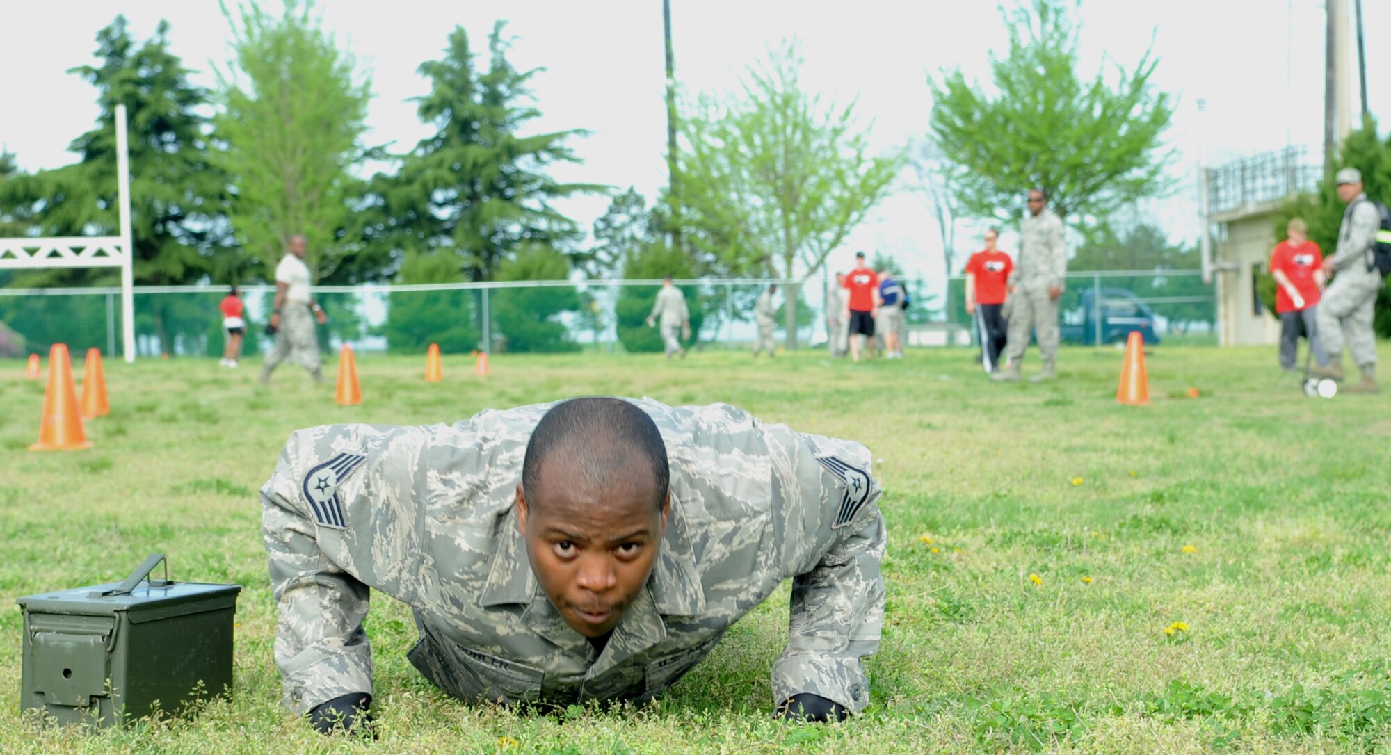 Staff Sgt. Steven Bohler, 8th Maintenance Squadron, pumps out his last pushup before completing the final 75-yard leg of the combat fitness test while carrying two 30-pound ammo cans during a combat fitness test May 2, 2012, at Kunsan Air Base, Republic of Korea. The CFT is a realistic way to assess how prepared someone is to handle the physical rigors of deployment. (U.S. Air Force photo/Senior Airman Brigitte N. Brantley)