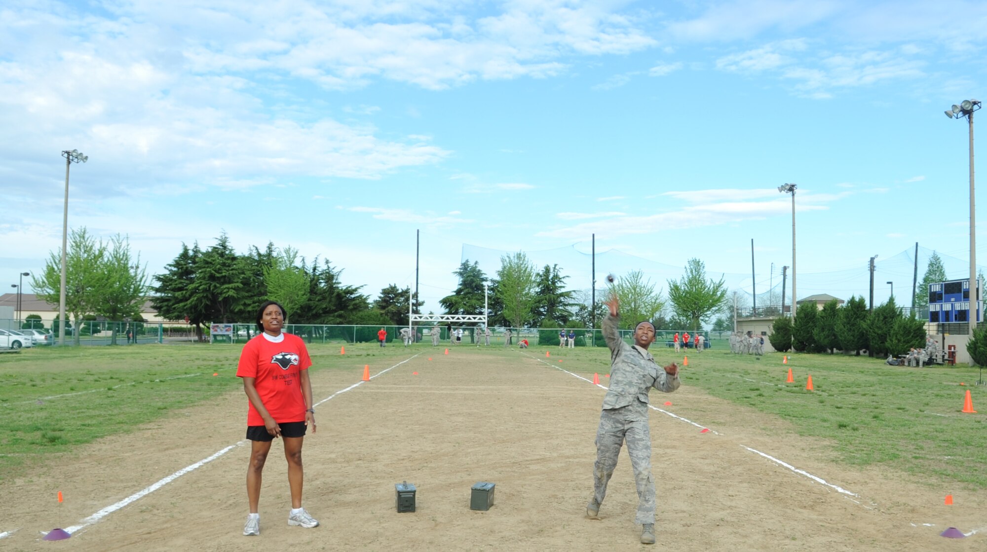 Senior Airman Emerald Twiggs, 8th Operations Squadron, throws a simulated grenade as cadre Tech. Sgt. Kellie Ford, 8th Fighter Wing Legal Office, instructs her during a combat fitness test May 2, 2012, at Kunsan Air Base, Republic of Korea. Twiggs and other members from her squadron participated in the CFT to challenge themselves. (U.S. Air Force photo/Senior Airman Brigitte N. Brantley)