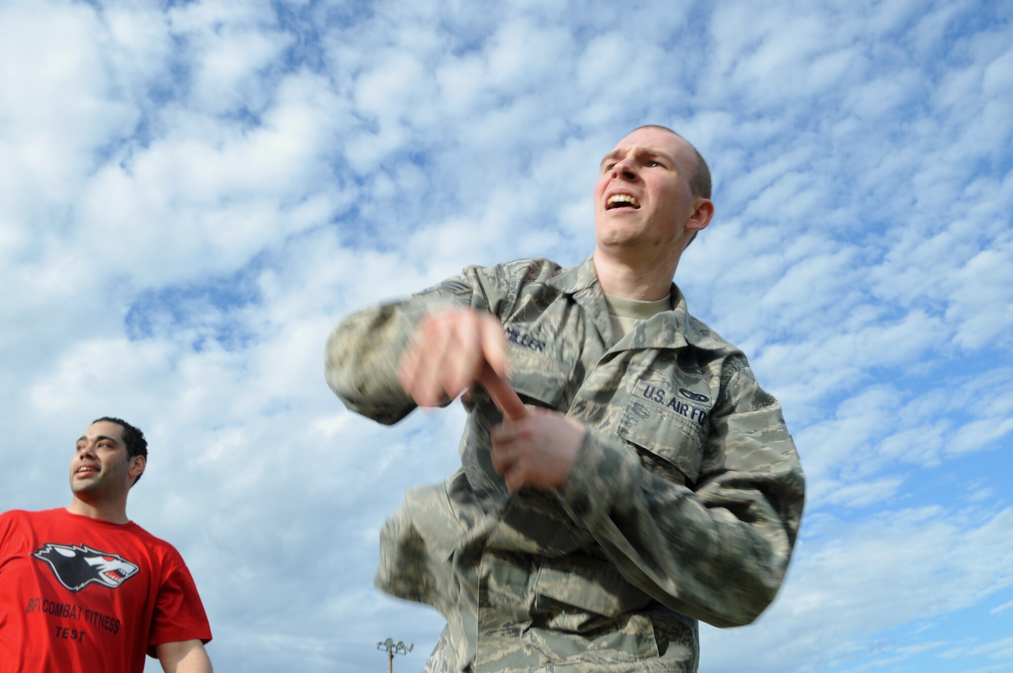 Senior Airman Charles Miller, right, 8th Logistics Readiness Squadron, completes a grenade throw upon the order from Staff Sgt. Steven Acevedo, 8th Maintenance Squadron, during a combat fitness assessment May 2, 2012, at Kunsan Air Base, Republic of Korea. In addition to this, Airmen also sprinted 800 meters, completed two minutes of 30-pound ammo can lifts, did low and high crawls . and carried their teammate 75 yards. (U.S. Air Force photo/Senior Airman Brigitte N. Brantley)