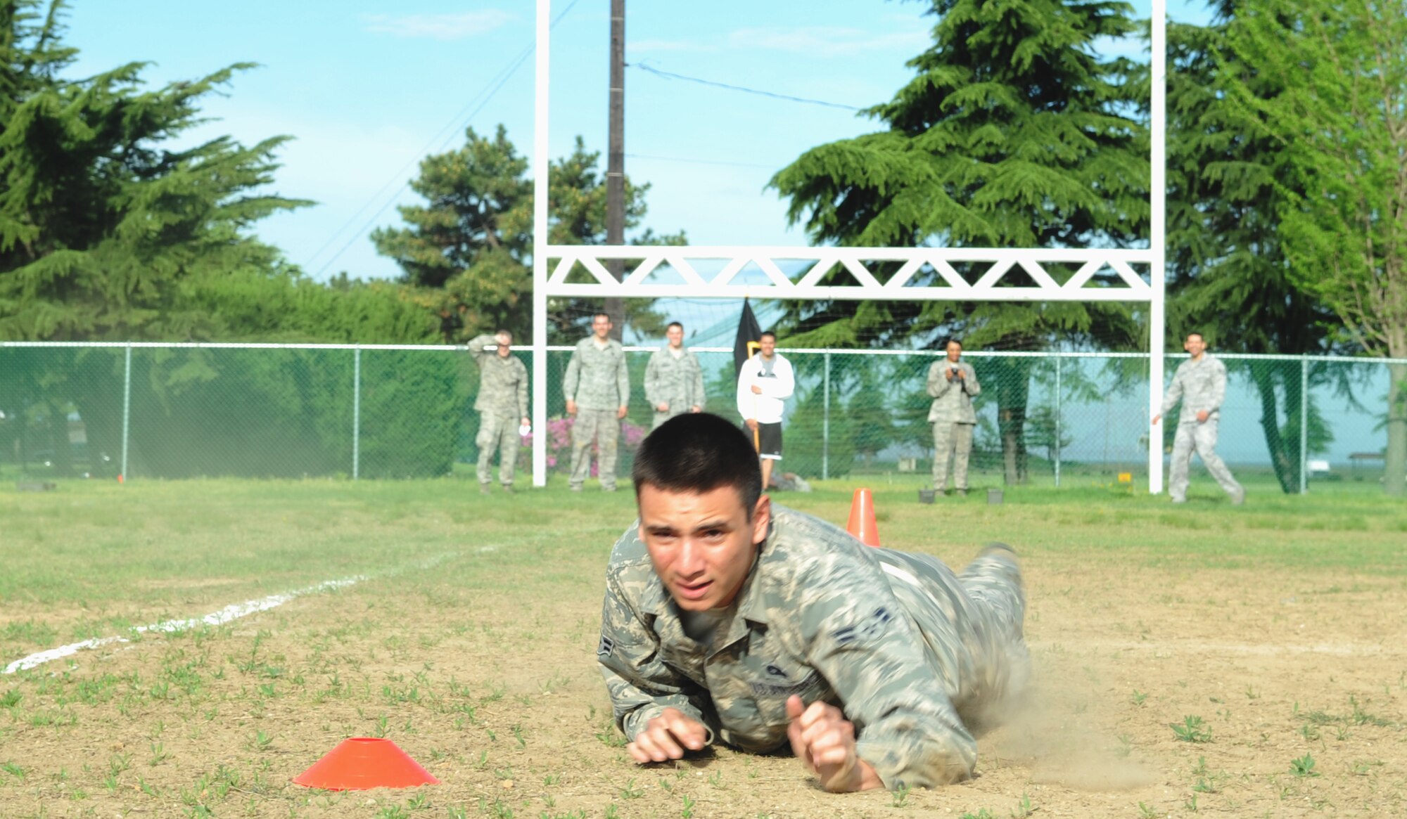 After sprinting 10 yards, an airman first class from the 8th Fighter Wing completes a low crawl before popping up into a high crawl during a combat fitness assessment May 2, 2012, at Kunsan Air Base, Republic of Korea. These maneuver-under-fire events simulate the actions service members might face while in combat. (U.S. Air Force photo/Senior Airman Brigitte N. Brantley)