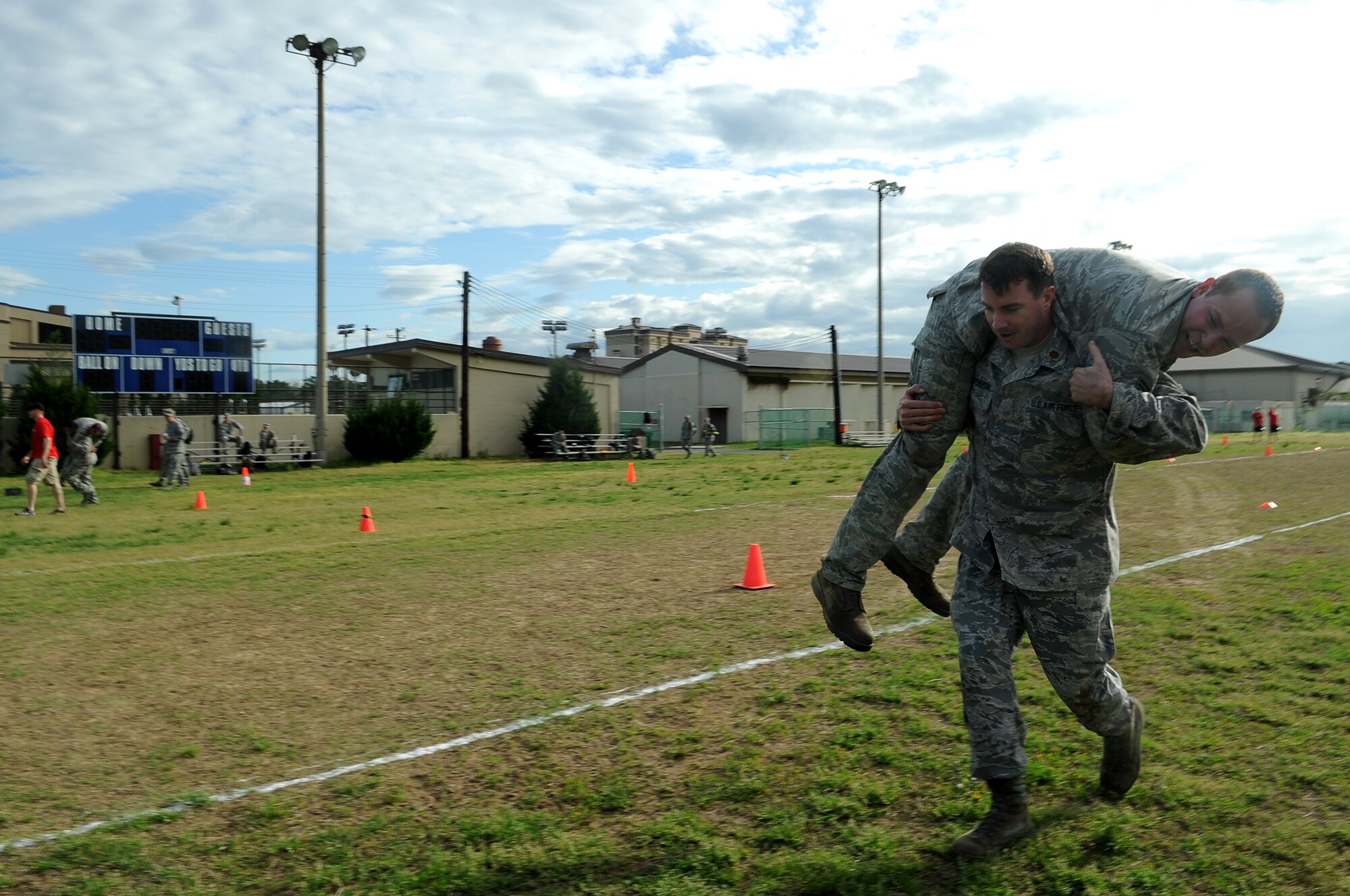 Maj. Ryan McPherson, left, 8th Operations Support Squadron, carries Staff Sgt. Brandon Coleman, 8th Maintenance Squadron, during the last leg of the combat fitness test held May 2, 2012, at Kunsan Air Base, Republic of Korea. The fireman’s carry represented moving an unconscious Wingman or casualty out of further harm’s way while under fire.  (U.S. Air Force photo/Senior Airman Brigitte N. Brantley)