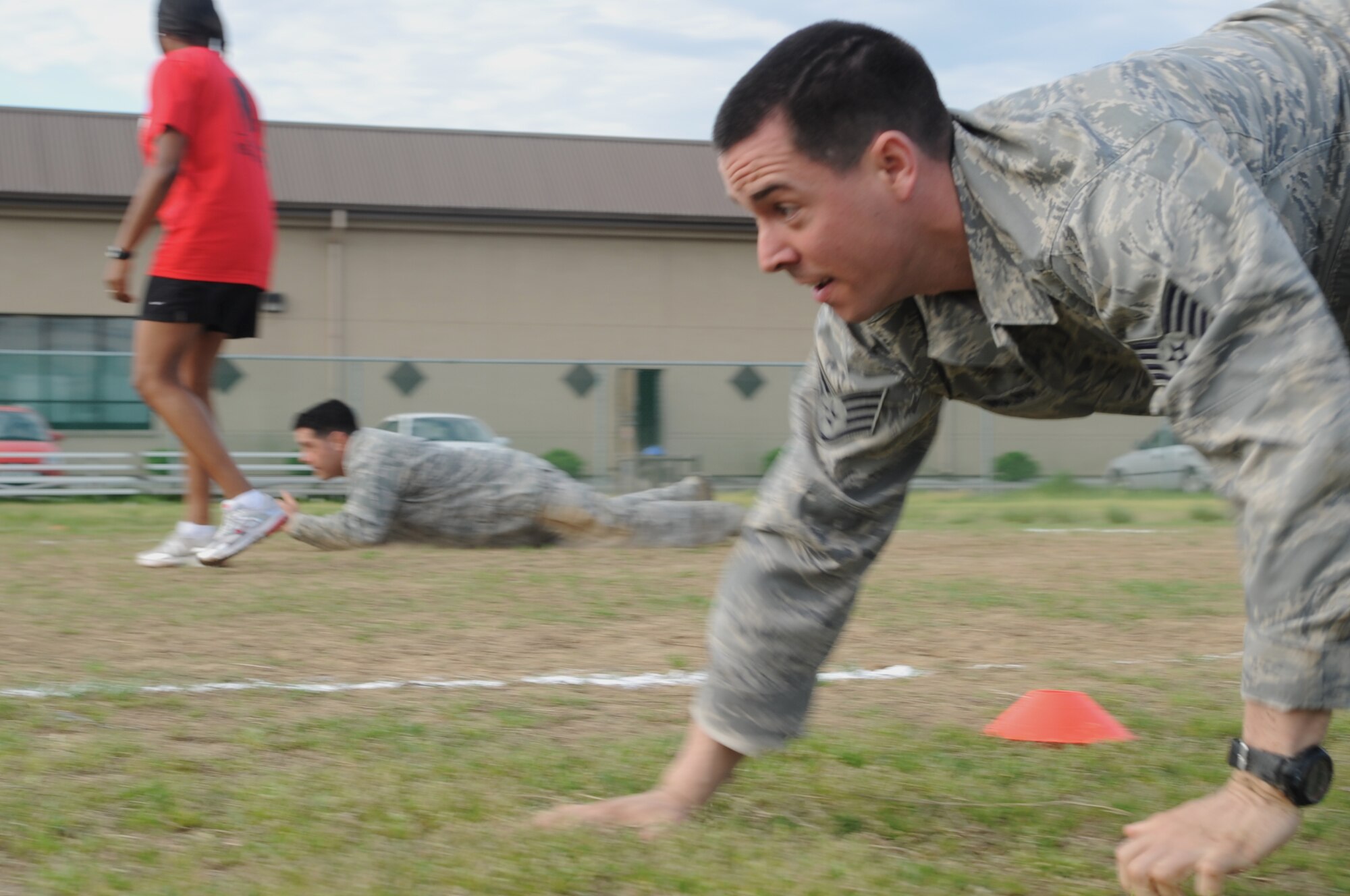 A staff sergeant from the 8th Fighter Wing transitions from a low crawl into a high crawl during a combat fitness test May 2, 2012, at Kunsan Air Base, Republic of Korea. These movements simulate the actions that may be needed while maneuvering under fire. (U.S. Air Force photo/Senior Airman Brigitte N. Brantley)