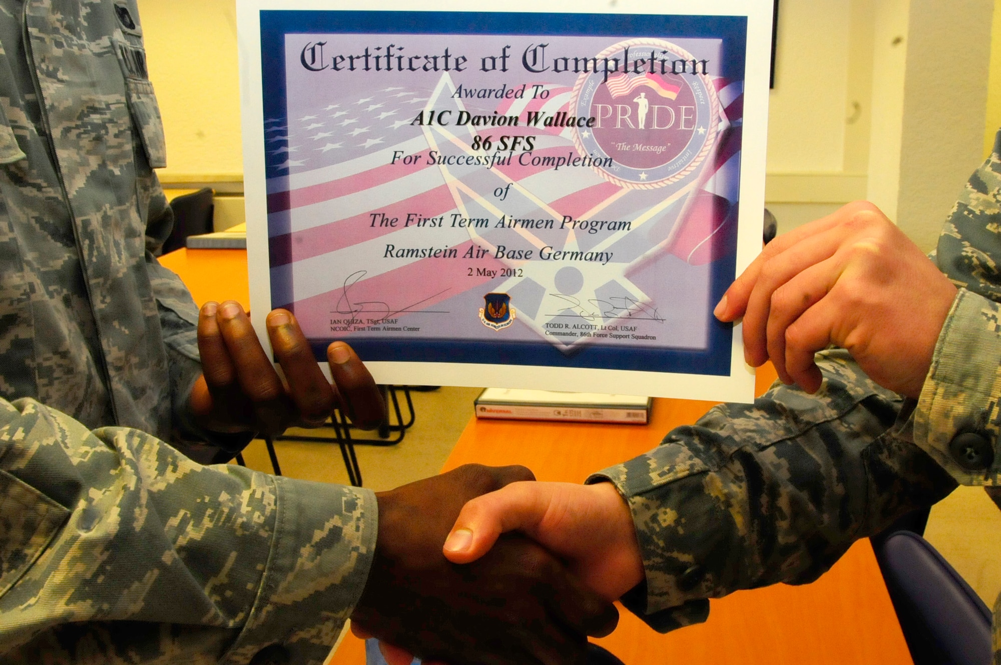 An Airman receives a certificate upon graduating the First Term Airman’s Center course May 2, on Ramstein Air Base. FTAC holds an eight-day class beginning every other Monday to help first-term Airmen get all the information they need about the base and all the services it has to offer. (U.S. Air Force photo/Airman 1st Class Hailey Haux)