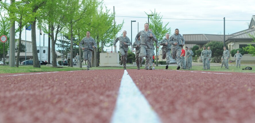 Airmen from the 8th Fighter Wing begin the 800-meter sprint portion of the combat fitness test held May 2, 2012, at Kunsan Air Base, Republic of Korea. The Airmen also completed 30-pound ammo can lifts, low and high crawls, buddy carries and a grenade throw. (U.S. Air Force photo/Senior Airman Brigitte N. Brantley)