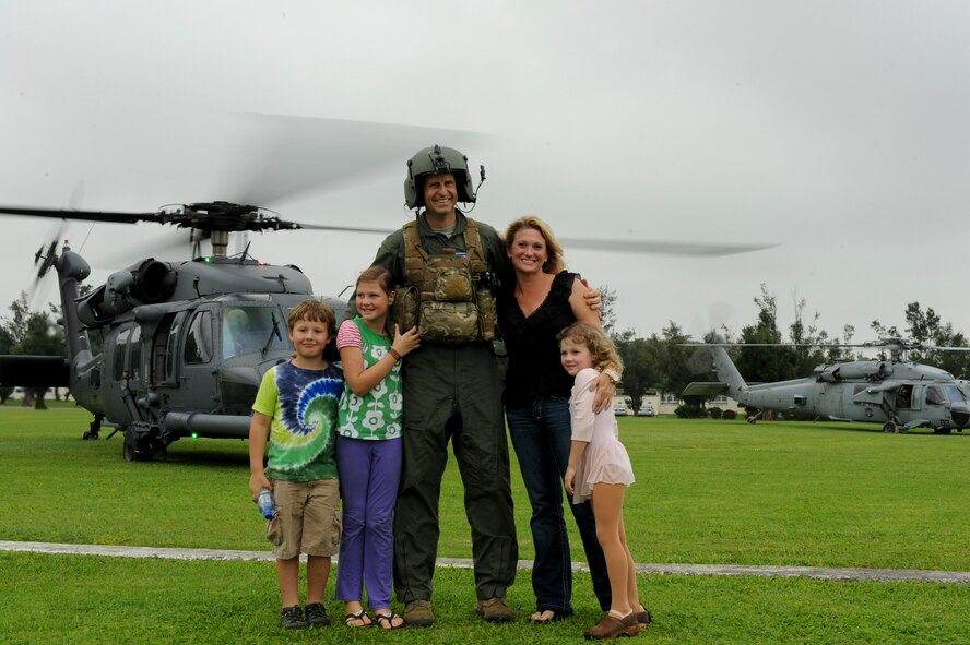U.S. Air Force Col. Corey Martin, 18th Wing vice commander, poses with his family after a “fini” flight with the 33rd Rescue Squadron on Kadena Air Base, Japan, May 2, 2012. Martin has been Kadena’s vice commander for a year and is preparing to continue on to his next duty station. (U.S. Air Force by Airman 1st Class Brooke P. Beers/Released)