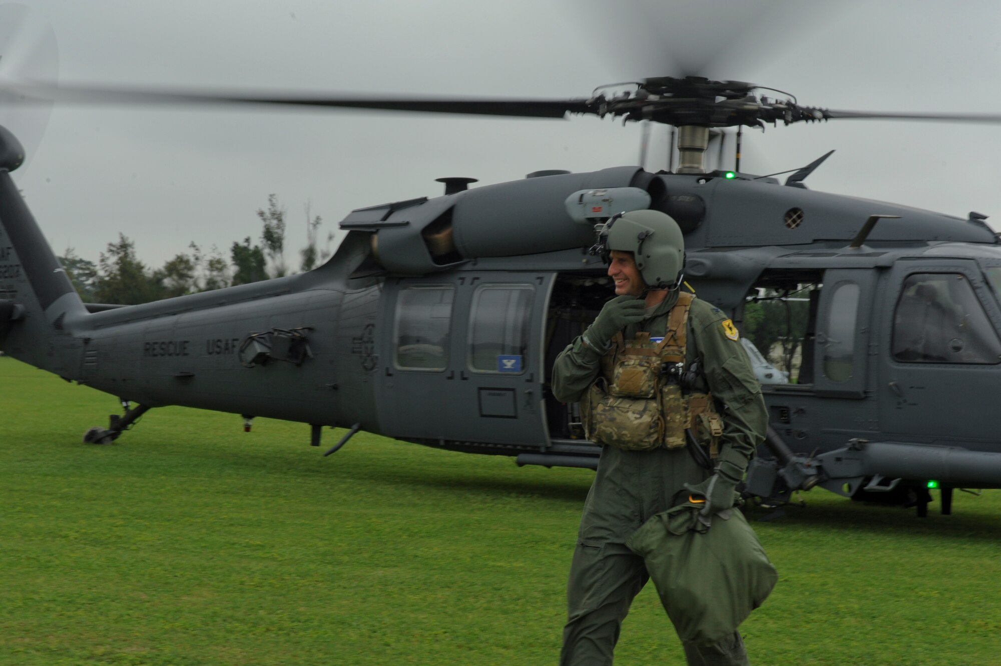 U.S. Air Force Col. Corey Martin, 18th Wing vice commander, walks away from a U.S. Air Force HH-60 Pavehawk helicopter after a “fini” flight with the 33rd Rescue Squadron on Kadena Air Base, Japan, May 2, 2012. Martin is preparing to leave Kadena and continue on to his next duty station. (U.S. Air Force by Airman 1st Class Brooke P. Beers/Released)