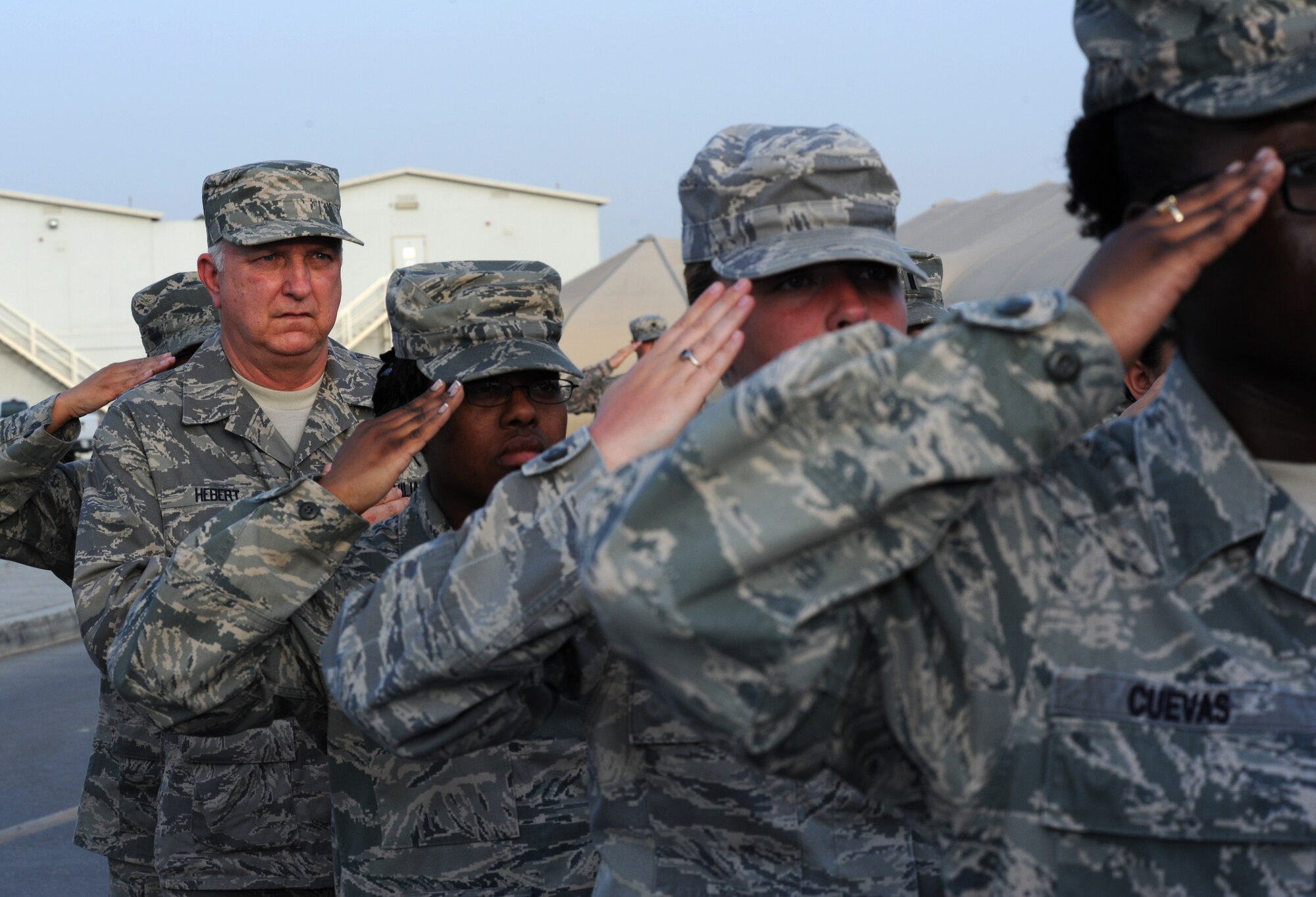 SOUTHWEST ASIA - Mitch Hebert takes part in the weekly retreat ceremony at the 380th Air Expeditionary Wing April 27, 2012. Hebert, the deputy commander of the 380th Expeditionary Force Support Squadron, is on the first deployment of his 31-year career as a civil servant. The Biloxi, Miss., native has held a variety of Air Force Services positions at bases all over the world, but deploying with Airmen to Southwest Asia has long been a career goal for him. (U.S. Air Force photo/Staff Sgt. J.G. Buzanowski)