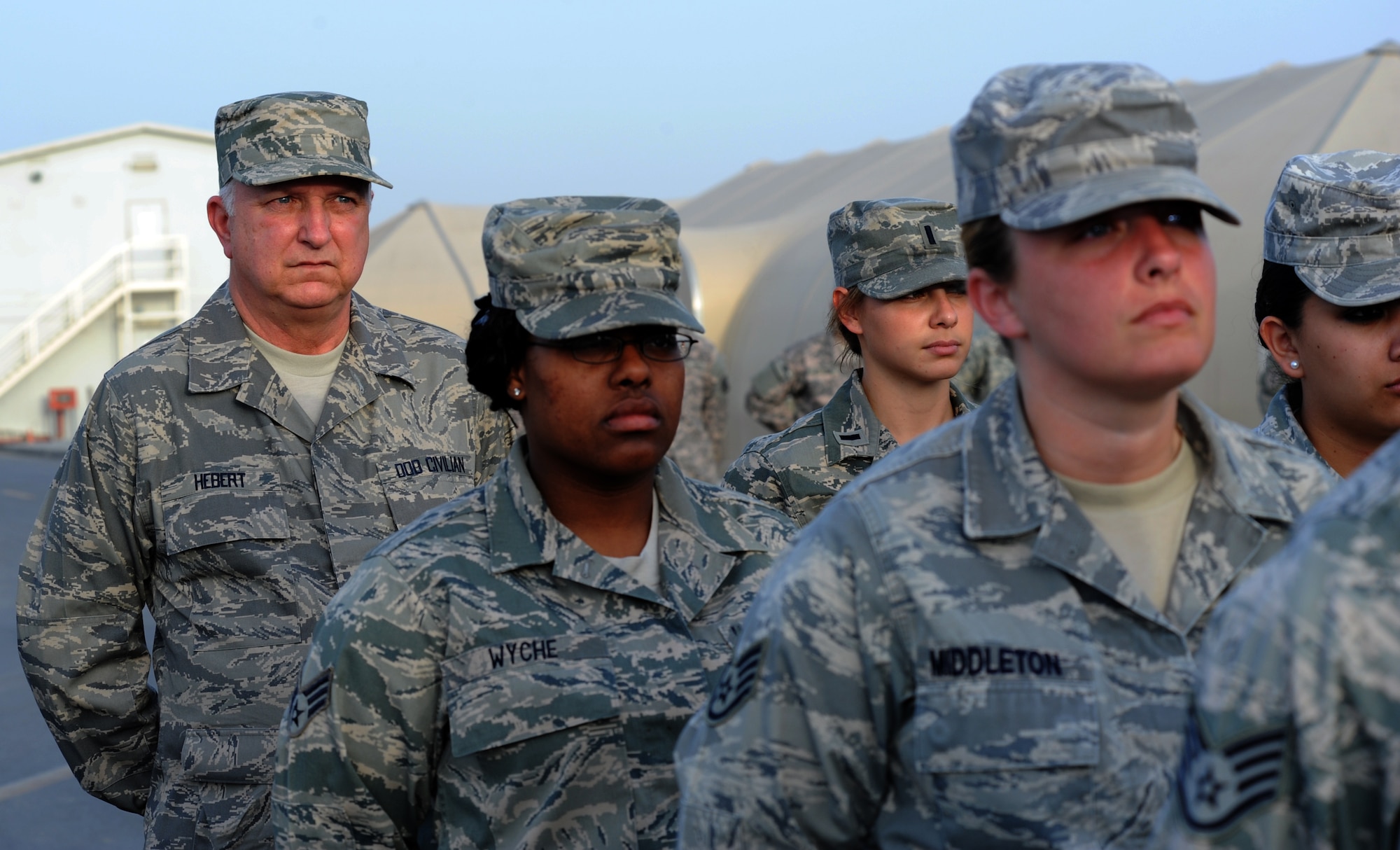 SOUTHWEST ASIA - Mitch Hebert takes part in the weekly retreat ceremony at the 380th Air Expeditionary Wing April 27, 2012. Hebert, the deputy commander of the 380th Expeditionary Force Support Squadron, is on the first deployment of his 31-year career as a civil servant. The Biloxi, Miss., native has held a variety of Air Force Services positions at bases all over the world, but deploying with Airmen to Southwest Asia has long been a career goal for him. (U.S. Air Force photo/Staff Sgt. J.G. Buzanowski)