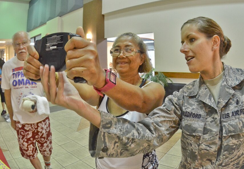 Tech. Sgt. Autumn Bradford, 36th Medical Operations Squadron Health and Wellness Center noncommissioned officer in charge, showed attendants how to use a body mass index and body fat calculator May 1. The HAWC provided a health fair for servicemembers and their dependants at the fitness center. The array of booths set up varied from the family advocacy program, education, healthy eating, immunizations and massage therapy. (U.S. Air Force photo by Staff Sgt. Alexandre Montes)