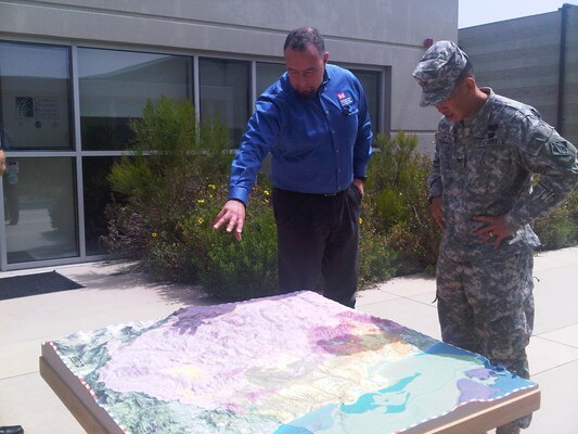 Kevin Wohlmut (left), a planner in the Coastal Studies Group for the Corps' Los Angeles District, discusses Tijuana River watershed issues with district commander Col. Mark Toy during a break at a meeting hosted April 19 by the International Boundary and Water Commission at the Tijuana River Estuary Visitors Center in Imperial Beach, Calif. 