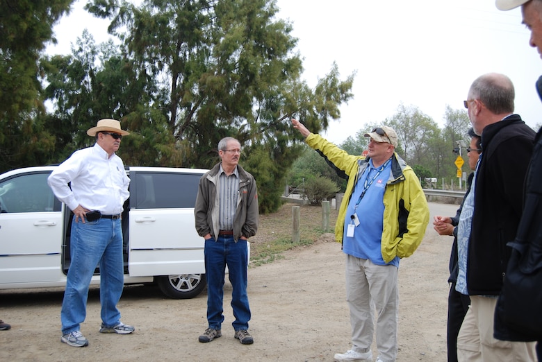 Robert Smith (right), a senior project manager with the Corps’ Carlsbad Regulatory Office, describes regulatory issues affecting the Tijuana River pilot channel and the brown field remediation site to Edward Drusina, head of the International Boundary and Water Commission (wearing hat), and other commission members during a visit to Tijuana River on April 20.