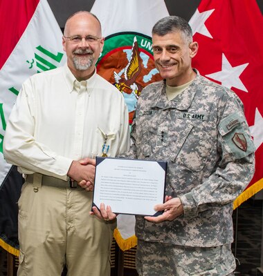 BAGHDAD — Douglas Harold Plachy, U.S. Army Corps of Engineers Program Manager, receives the Joint Civilian Service Commendation Medal from Lt. Gen. Robert Caslen Jr. during a ceremony here, April 24, 2012. Plachy is deployed from the USACE Kansas City District.