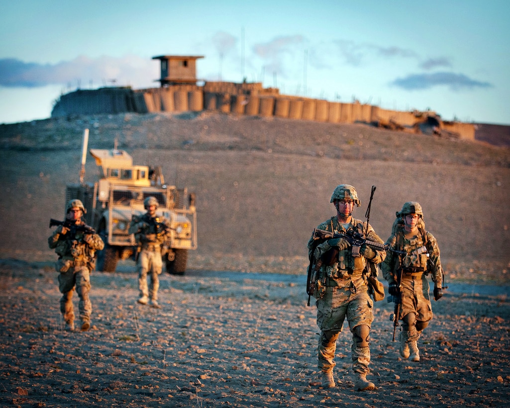 U.S. Army Sgt. 1st Class Jason Gregory and Pfc. Colton Unger are joined by fellow paratroopers as they leave an Afghan army compound during a combined patrol clearing operation in Afghanistan's Ghazni province, April 30, 2012. Gregory, a platoon sergeant, is assigned to the 82nd Airborne Division’s 1st Brigade Combat Team.
