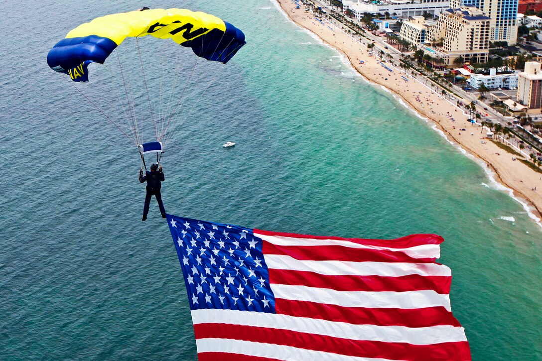 James Woods flys an 800-square-foot American flag during a rehearsal for the Lauderdale Air Show in Fort Lauderdale, Fla., April 27, 2012. Woods is assigned to the U.S. Navy parachute demonstration team, the Leap Frogs.