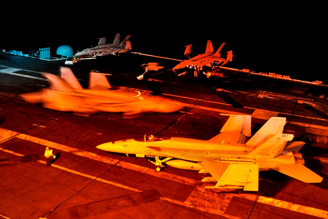 Aircraft taxi on the flight deck of the aircraft carrier USS Dwight D. Eisenhower as they prepare for flight operations in the Atlantic Ocean, May 1, 2012. The Eisenhower, the flagship for Carrier Strike Group 8, is conducting a training exercise.