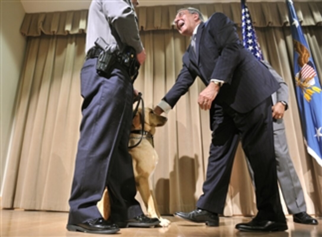Secretary of Defense Leon E. Panetta pauses to greet a police dog after being given the Bravo Award by Deputy Director of the Pentagon Force Protection Agency Jonathan Cofer during the Pentagon Force Protection Agency's 10-year anniversary celebration at the Pentagon on May 2, 2012.  PFPA was established as a Defense Agency on May 3, 2002, in response to the Sept. 11, 2001, terror attacks and the October 2001 anthrax attacks. 