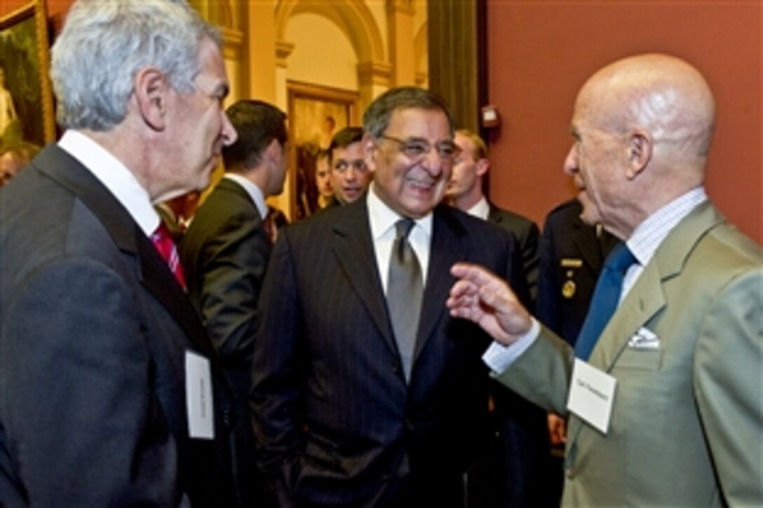 Defense Secretary Leon E. Panetta speaks with Fred Krupp, left, president of the Environmental Defense Fund, and Carl Ferenbach, right, chairman of the its board of trustees, at the annual reception for the organization at the Renwick Gallery in Washington, D.C., May 2, 2012. Panetta thanked the organization for recognizing Defense Department efforts to make military bases and equipment more efficient and environmentally friendly.