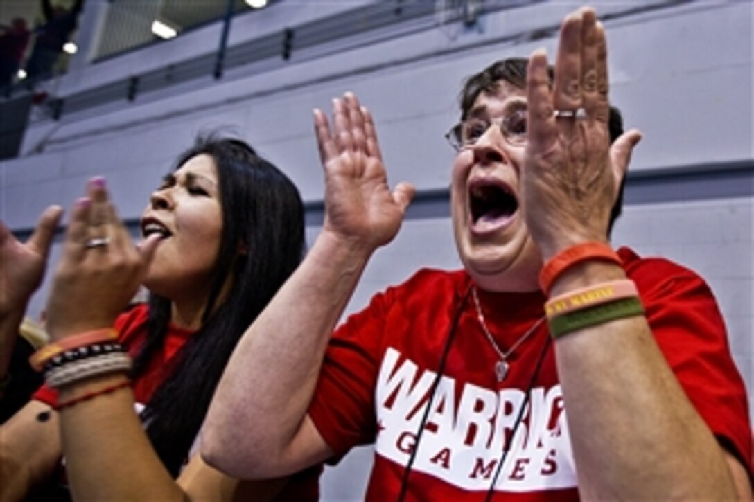 Leigh Jones, right, the mother of Marine Corps Cpl. Justin Jones, and Nayelli, Jones' wife, rejoice after seeing the corporal win the gold medal in the compound bow portion of the 2012 Warrior Games at the U.S. Air Force Academy in Colorado Springs, Colorado, May 2, 2012. Marines won four medals in the archery competition, including two golds and two bronzes.