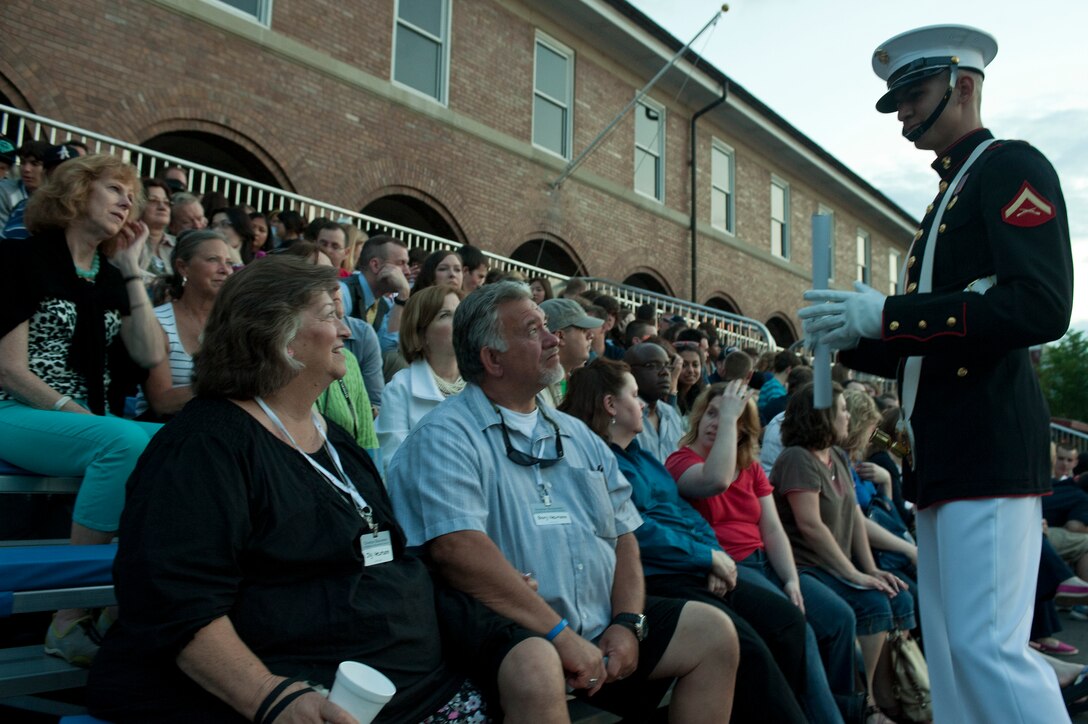 Lance Cpl. Alvaro Hernandez, Marine Corps Color Guard supernumerary, talks to guests before the Friday Evening Parade at Marine Barracks Washington, May 4, 2012. Hernandez educates the crowd before every evening parade, teaching them about the history of the oldest post of the Corps.