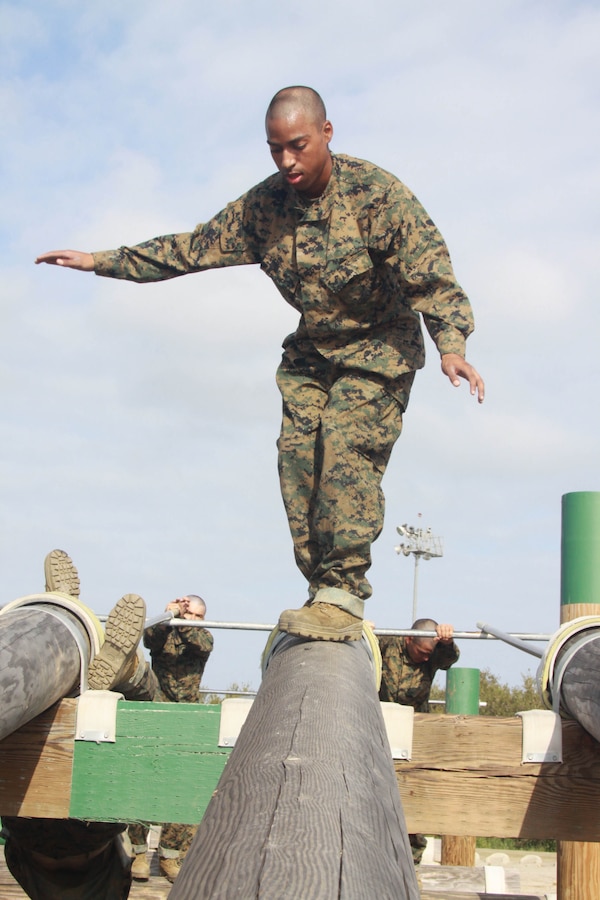 A Company A recruits walks down a log May 3 aboard Marine Corps Depot San Diego. This was one of the many events recruits had to complete while taking on the Obstacle Course during week two. At the end of the log recruits had to launch their bodies onto another log and swing their bodies over.