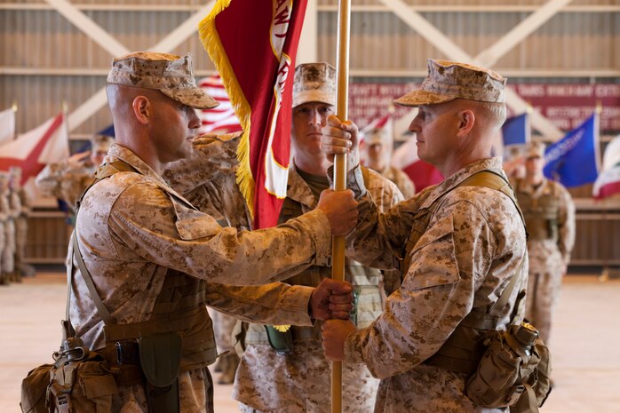 U.S. Marine Corps Lt. Col. Richard E. Petersen of the Marine All-Weather Fighter Attack Squadron 242, right, passes the guidon to Lt. Col. Bruce D. Gordon, at the change of command ceremony at Marine Corps Air Station Iwakuni, Japan, May 4, 2012. The ceremony recognized the change of command from U.S. Marine Corps Lt. Col. Richard E. Petersen to Lt. Col. Bruce D. Gordon. (U.S. Marine Corps photo by Lance Cpl. Todd F. Michalek/Released)
