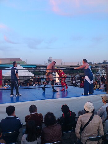 Sgt. Gaylon Summers, Marine Aviation Logistics Squadron 12 ground safety manager and aspiring professional wrestler, grapples with Azteca, a wrestler, at an outdoor match in Fukuoka, Japan, May 4, 2012. Summers was awarded an opportunity to train in New Japan Pro-Wrestling's dojo in the coming months.