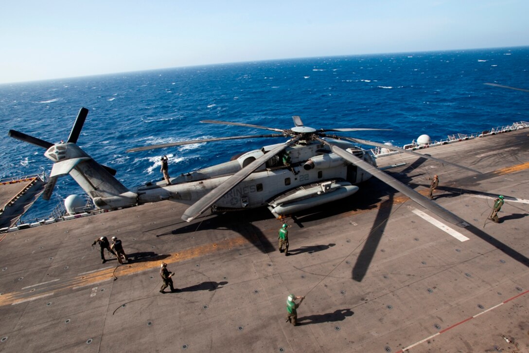 Marines tie down a CH-53E Super Stallion aboard USS Makin Island here May 3. The Marines serve with Marine Medium Helicopter Squadron 268 (Reinforced), the aviation combat element for the 11th Marine Expeditionary Unit. The unit is deployed as part of the Makin Island Amphibious Ready Group, currently a U.S. Central Command theater reserve force. The group is providing support for maritime security operations and theater security cooperation efforts in the U.S. Navy's 5th Fleet area of responsibility.