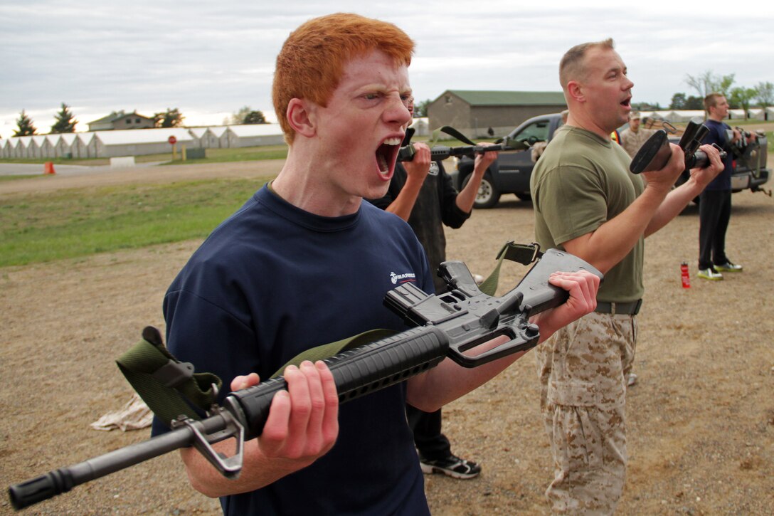 Cole Peloquin, a 17-year-old junior at Chisago Lakes High School, and Master Sgt. Thomas Andrews, Recruiting Substation Coon Rapids staff noncommissioned officer in charge, perform curls with dummy rifles during a circuit course at the 2012 Recruiting Station Twin Cities Mini Boot Camp May 4. For additional imagery from the event, visit www.facebook.com/rstwincities.