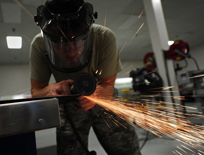 Staff Sgt. Joshua Hedden, 92nd Maintenance Squadron aircraft structural maintainer, uses a high speed cut off wheel to upgrade a control panel access door of a KC-135 Stratotanker for aerospace ground equipment at Fairchild Air Force Base, Wash., April 26, 2012. Technicians combat corrosion by visually identifying it, removing it by sanding or grinding methods and restoring the paint. (U.S. Air Force photo by Airman 1st Class Taylor Curry/Released)
