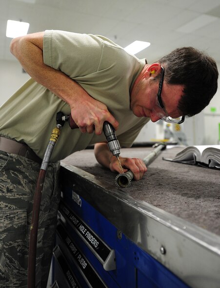 Staff Sgt. Joshua Hedden, 92nd Maintenance Squadron aircraft structural maintainer, removes jo-bolts from the main landing gear torque tube of a KC-135 Stratotanker in the Aircraft Structural Maintenance shop at Fairchild Air Force Base, Wash., April 26, 2012. Due to the age of the KC-135 Stratotanker and the heavy load it carries, a lot of the maintenance performed by this section deals with corrosion and cracks. (U.S. Air Force photo by Airman 1st Class Taylor Curry/Released)